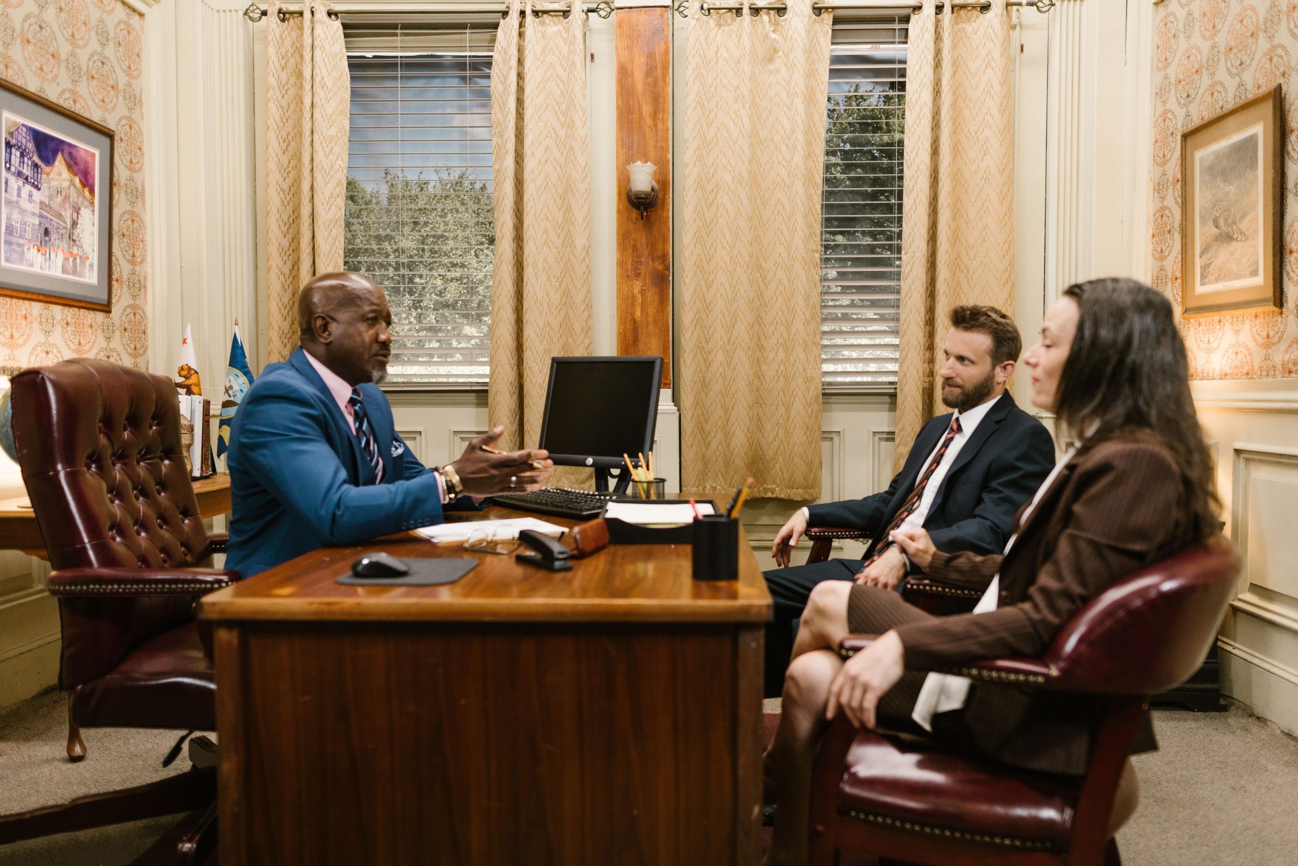 Divorce Family Law attorney consulting with clients at his desk